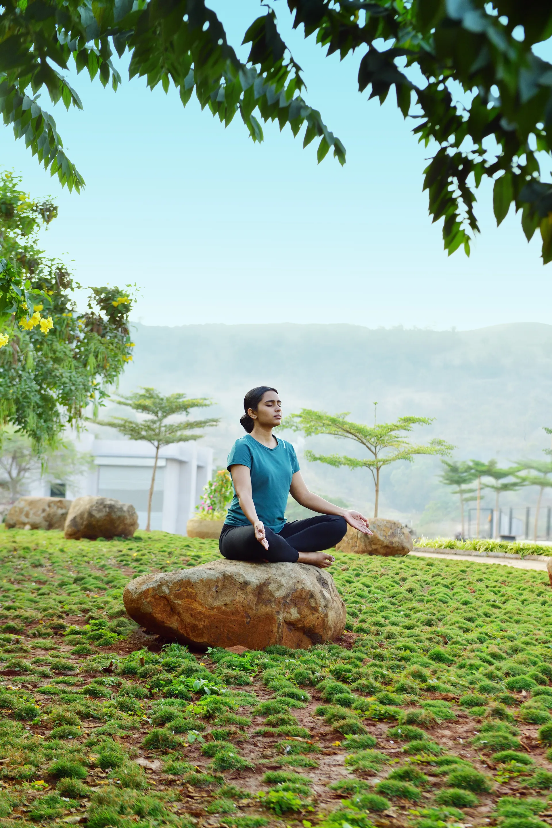 A resident on the landscaped grounds at Kekarav, the hills beyond