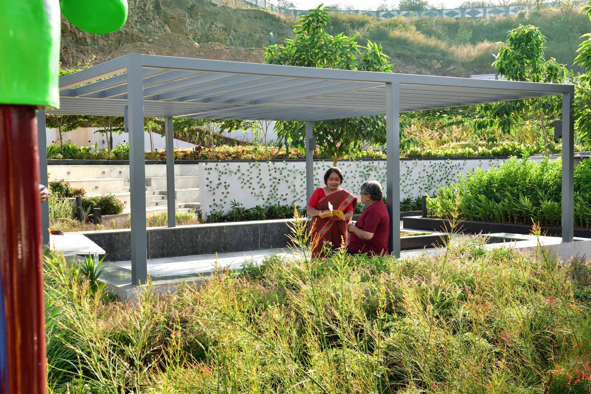 Residents at a pavilion amid the landscaping at Kekarav